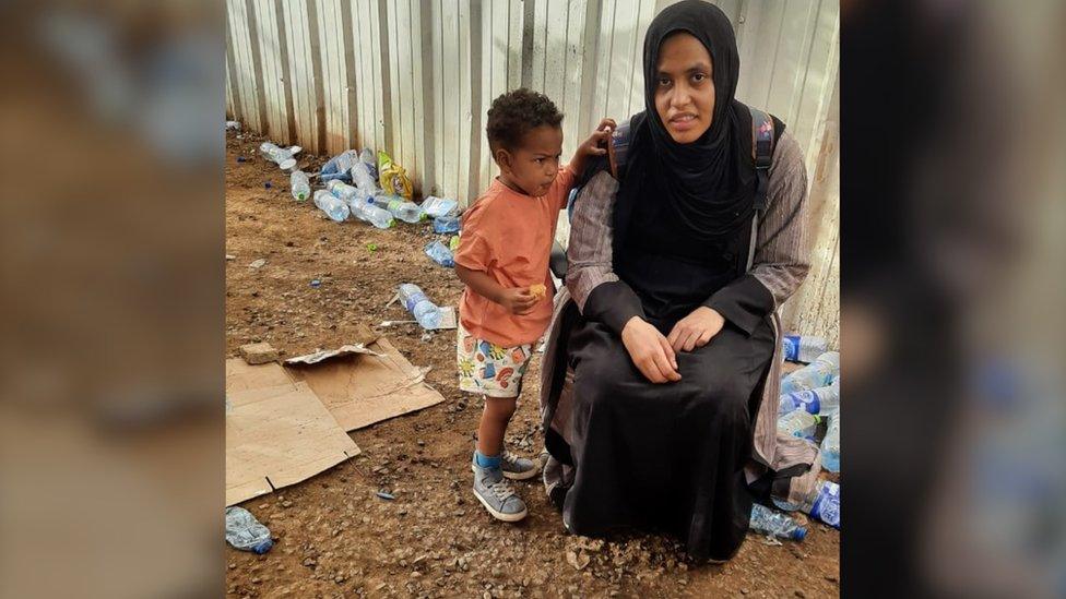 Niam with her son Yousif at the evacuation airport