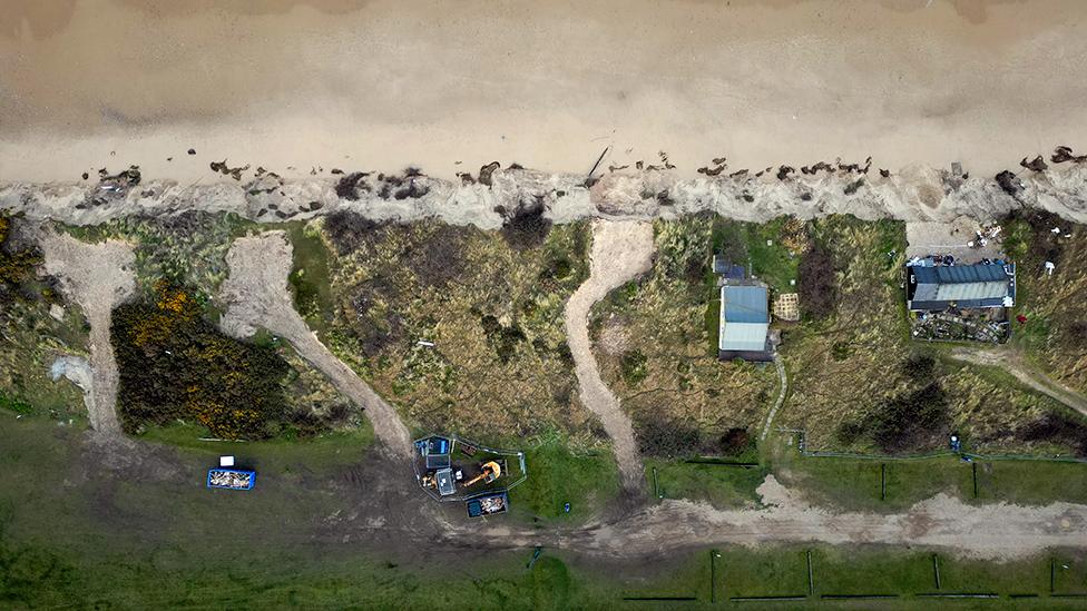 Aerial image of the Hemsby cliffs showing three gaps where properties once stood