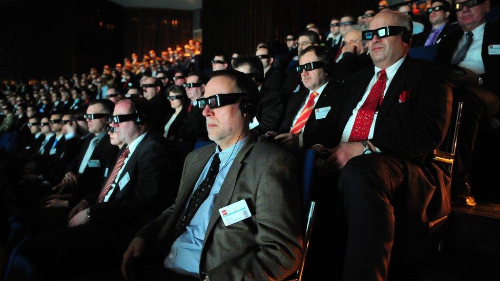 An audience watches a 3D movie