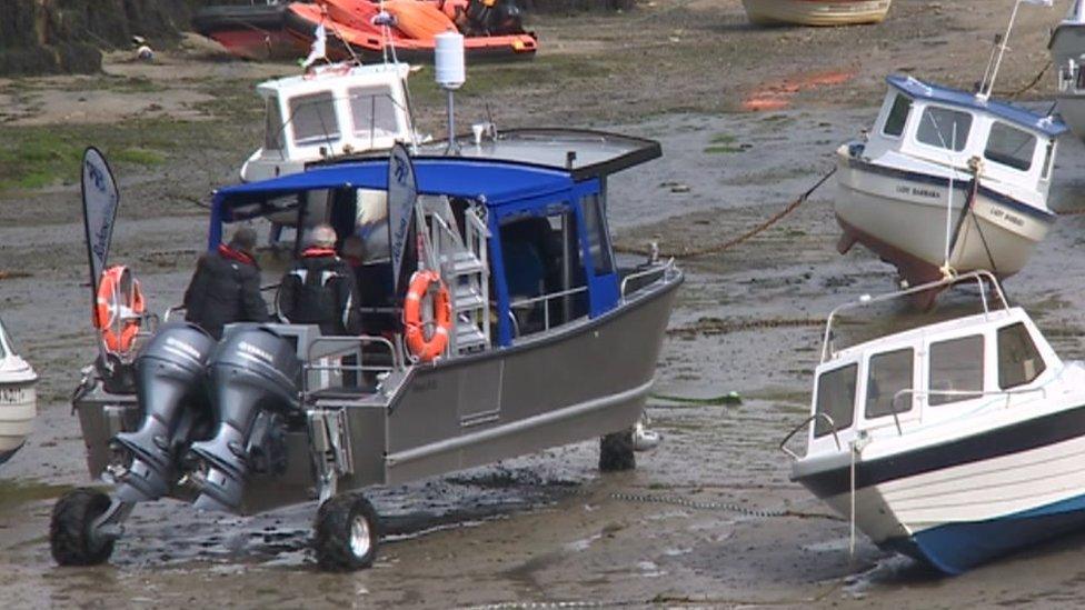 Ferry boat makes its way down the quay using its wheels