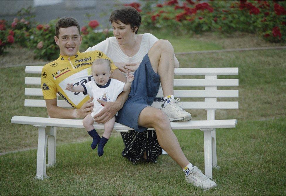 British racing cyclist Chris Boardman celebrates winning the yellow jersey after the first day of the Tour de France, with his wife Sally Anne, and one of their chidren, 2nd July 1994