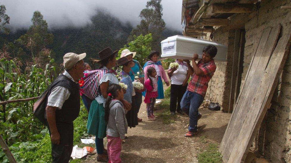 The remains of a victim of civil war in Peru on the way to a funeral