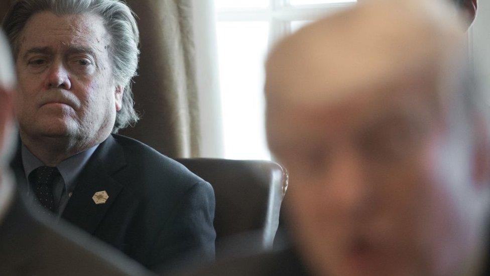 Steve Bannon watches as Donald Trump speaks