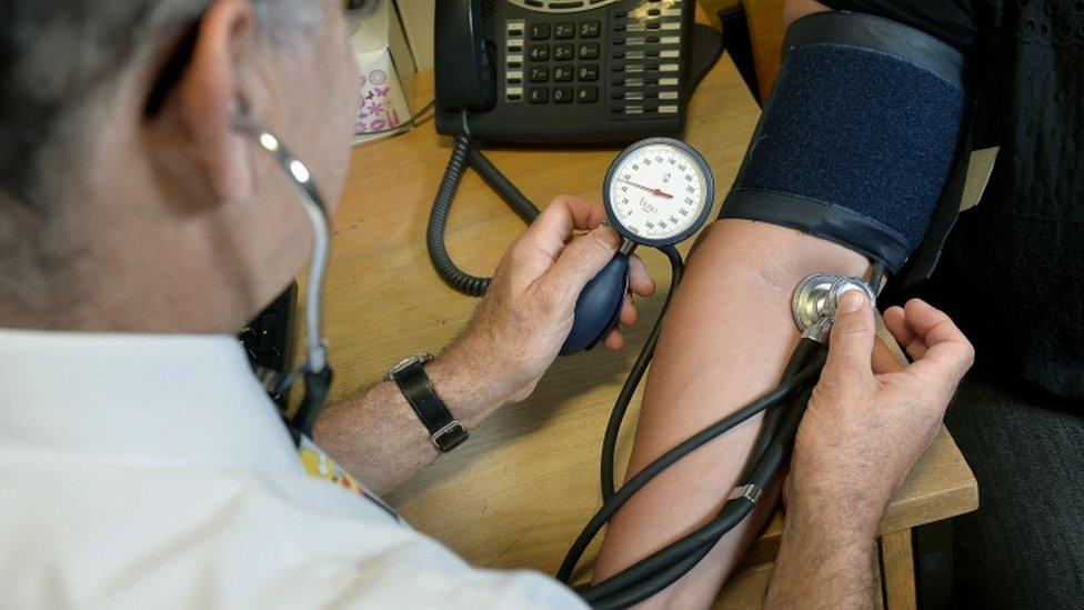 Doctor checking a patient's blood pressure