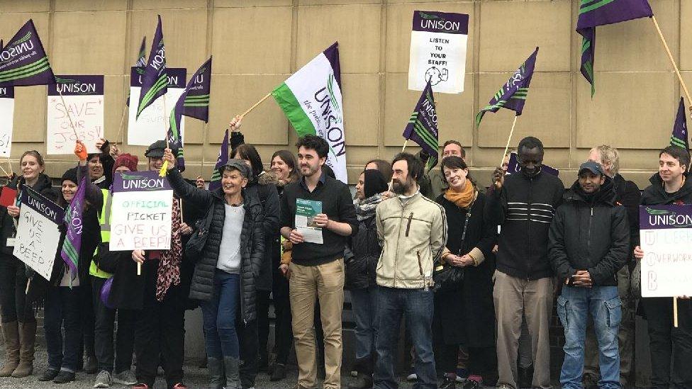 People with placards on a picket line