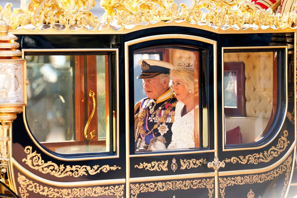 The Royal Standard flies as the horses and coach carrying the Imperial State Crown leaves Buckingham Palace, London, ahead of the King's Speech at the State Opening of Parliament in the House of Lords.