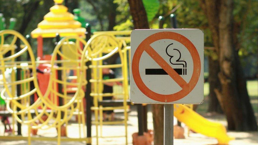 A playground with a no smoking sign