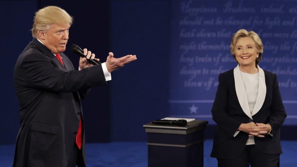 Republican presidential candidate Donald Trump speaks with Democratic opponent Hillary Clinton during the second presidential debate at Washington University in St Louis, 9 October 2016