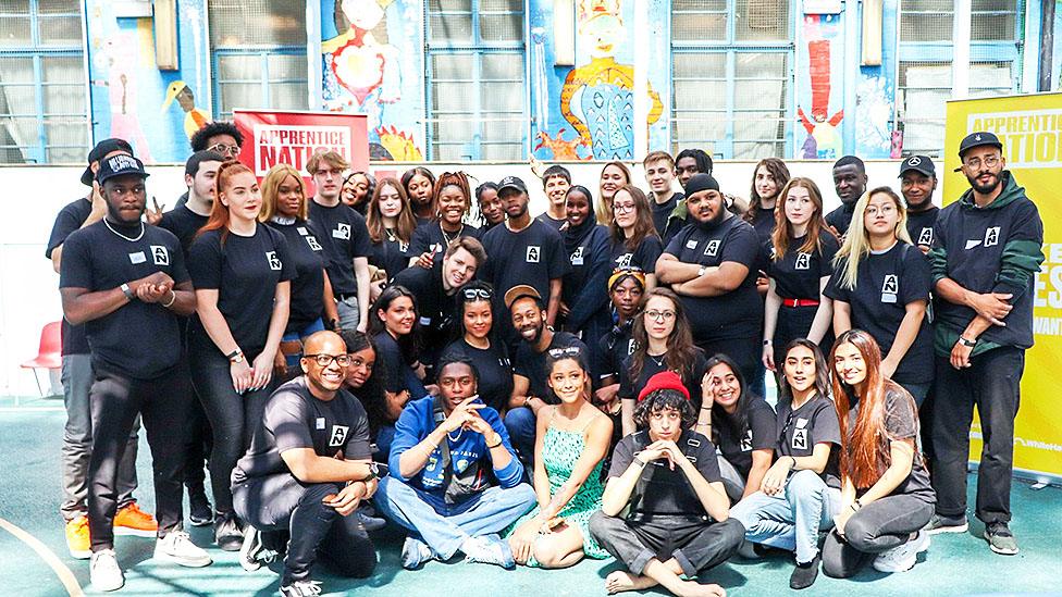 A group of young apprentices outside the venue of the gig