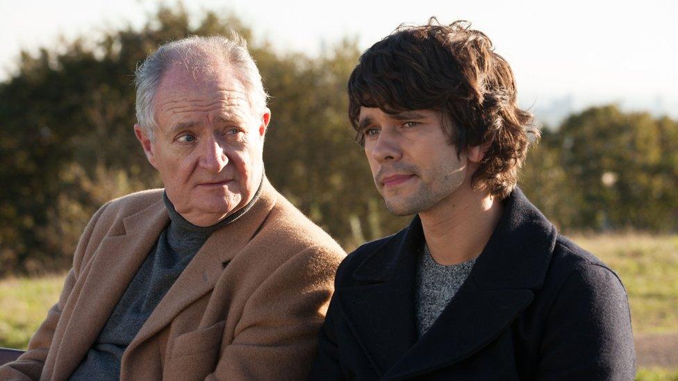 Jim Broadbent and Ben Whishaw sit on a bench in a London park