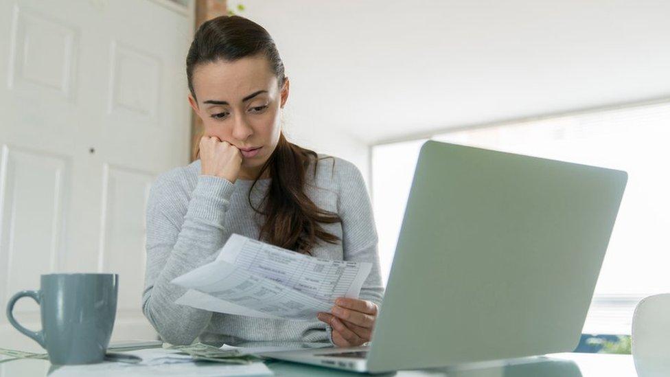 Woman looking at a bill