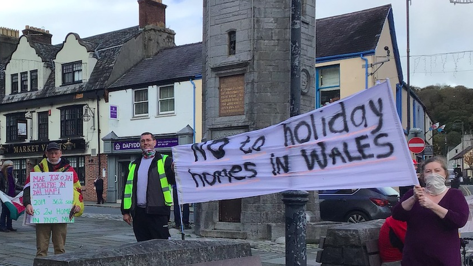 Protesters held signs saying no more second homes