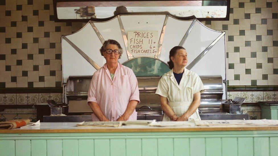 Two ladies in fish and chip shop