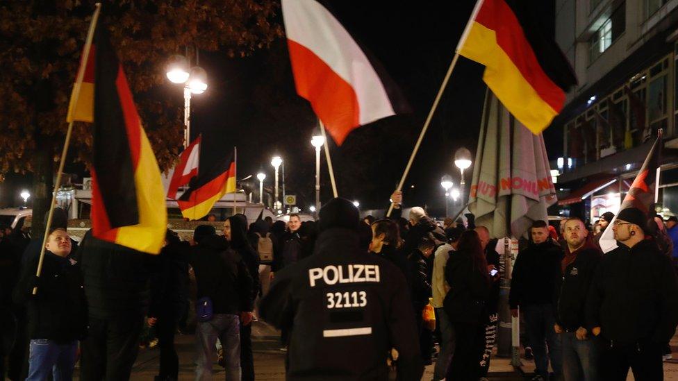 Far-right protestors demonstrate with flags under the motto "Close the borders" near the Kaiser-Wilhelm-Gedaechtniskirche (Kaiser Wilhelm Memorial Church), two days after an attack at the nearby Christmas market in central Berlin, on December 21, 2016.