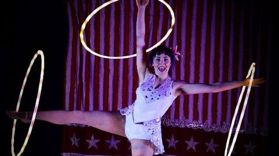 Circus Starr performer with fluorescent hula-hoops