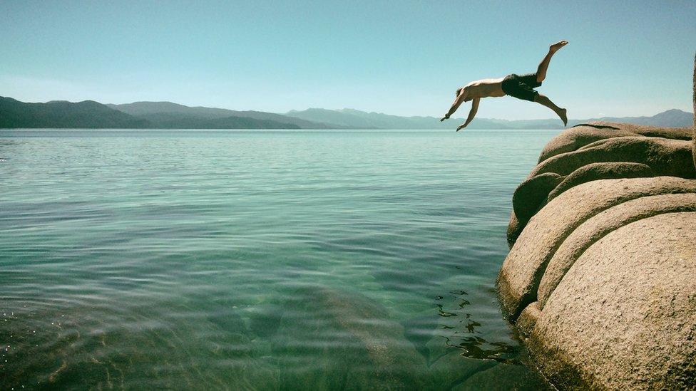 Diving off rocks into shallow water