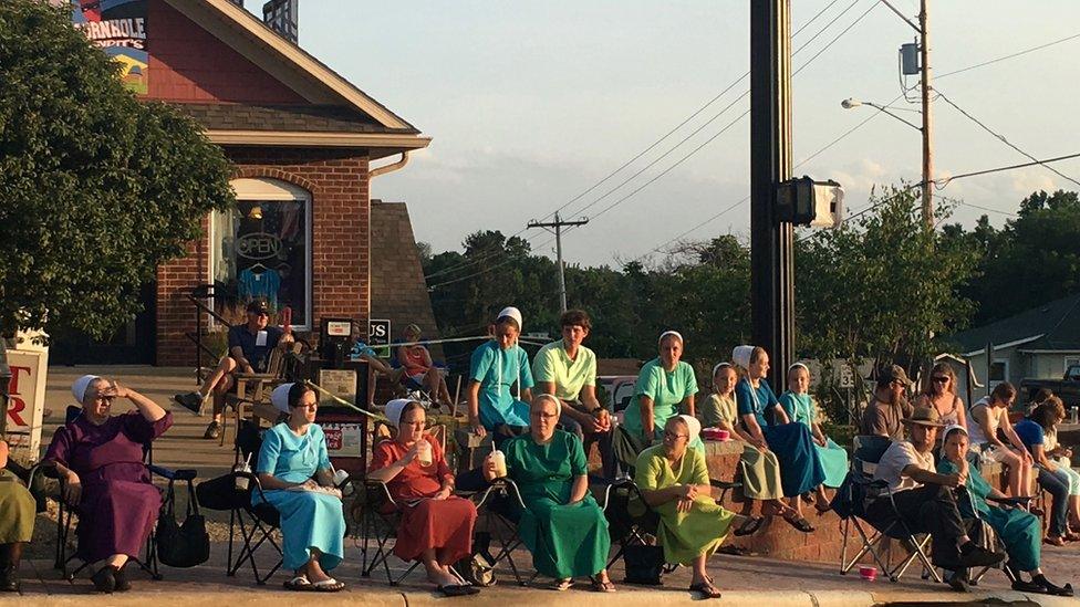 Amish watching truck parade