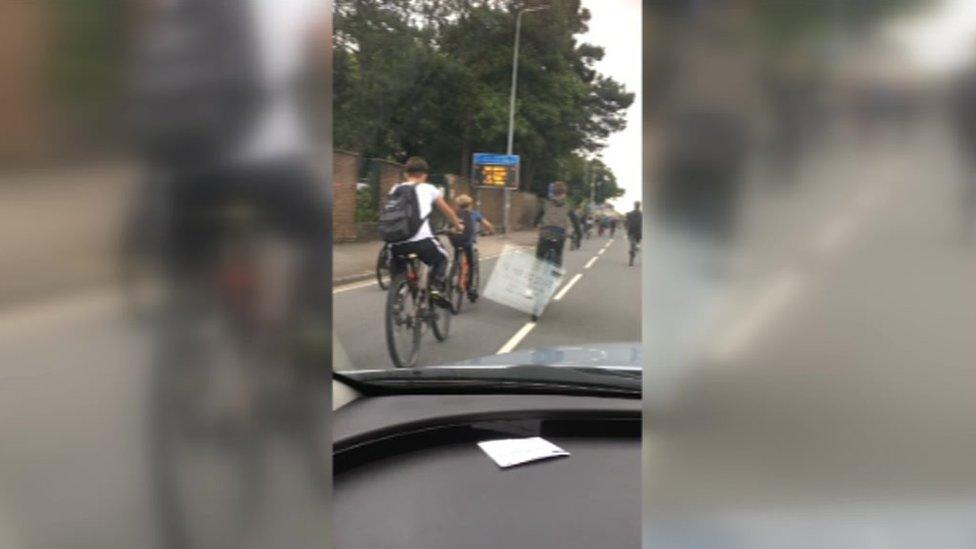 Group of cyclists in front of cars on North Road, Cardiff