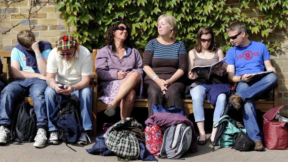 People wait for play to start at Wimbledon