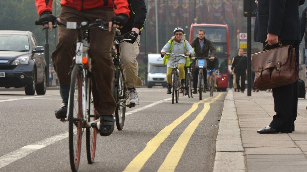 Commuters cycling, walking and driving in London