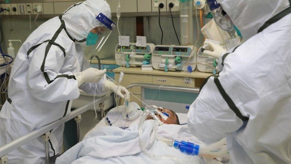 Medical staff treat a patient with pneumonia caused by the new coronavirus in Wuhan