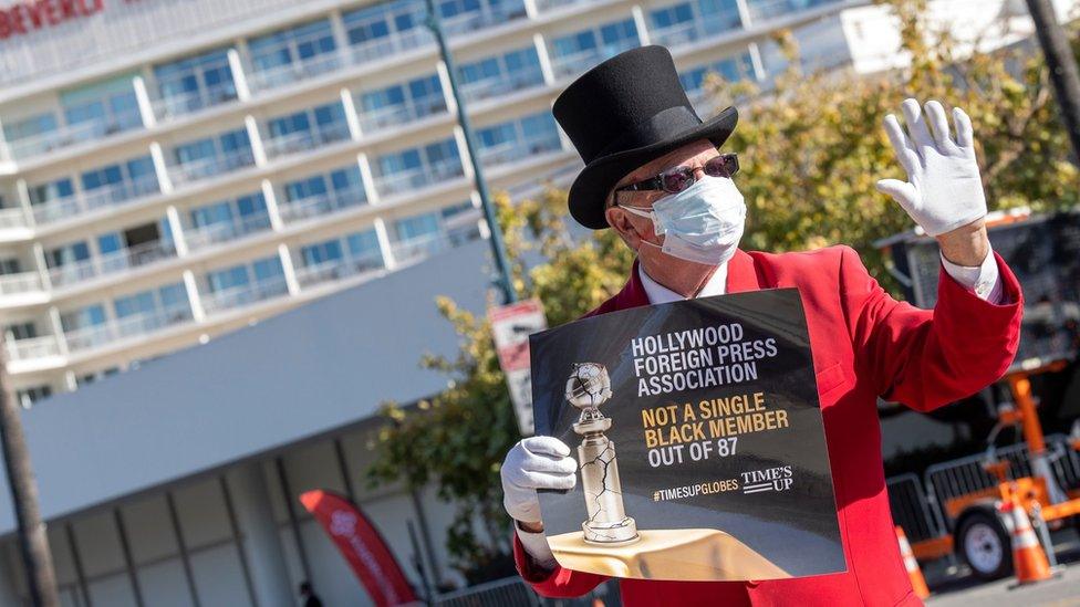 Man protesting ahead of Golden Globe awards this year in Los Angeles