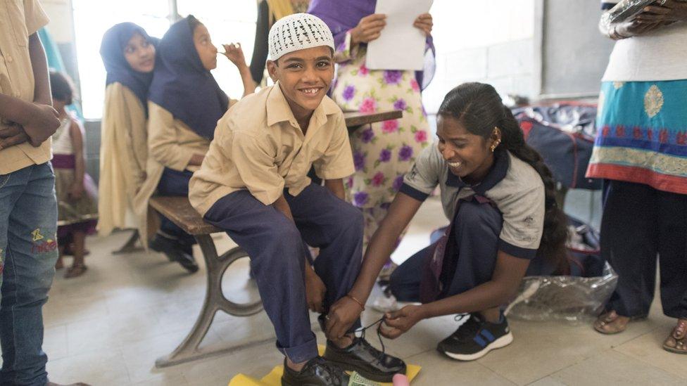 A child wearing Toms's shoes