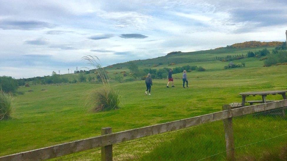 People walking across Swanston Golf Course