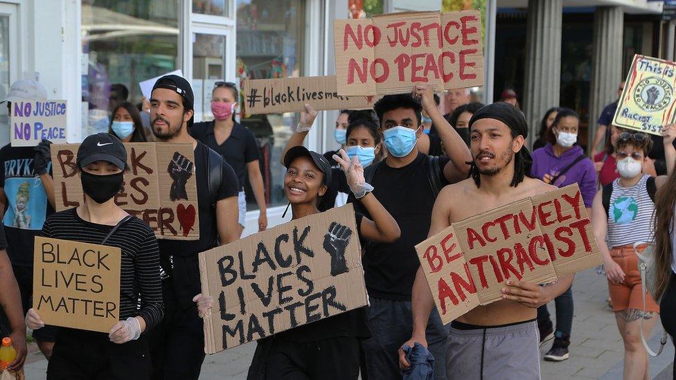 People gathered in Hemel Hempstead town centre with "Black Lives Matter" placards