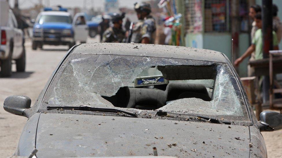 The aftermath of a car bombing in the Dora district of Baghdad showing a car with destroyed windscreen