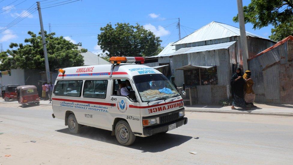 An ambulance is seen near a blast site that rocked a military base in Mogadishu