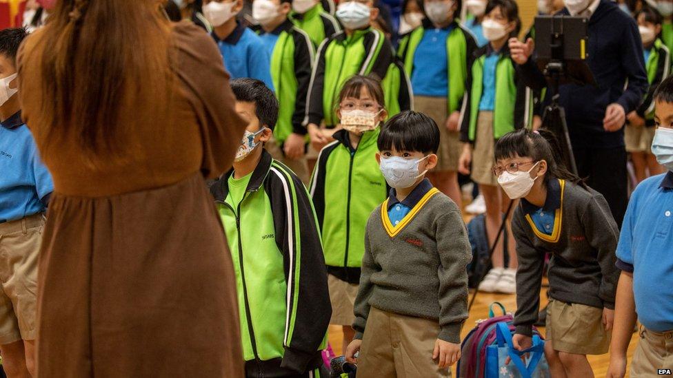 children at a primary school in hong kong wearing masks