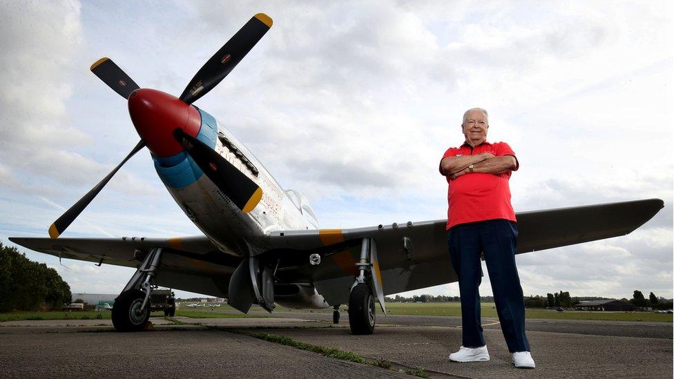 Lieutenant Colonel George Hardy standing next to his P51D Mustang plane at North Weald Airfield in Essex