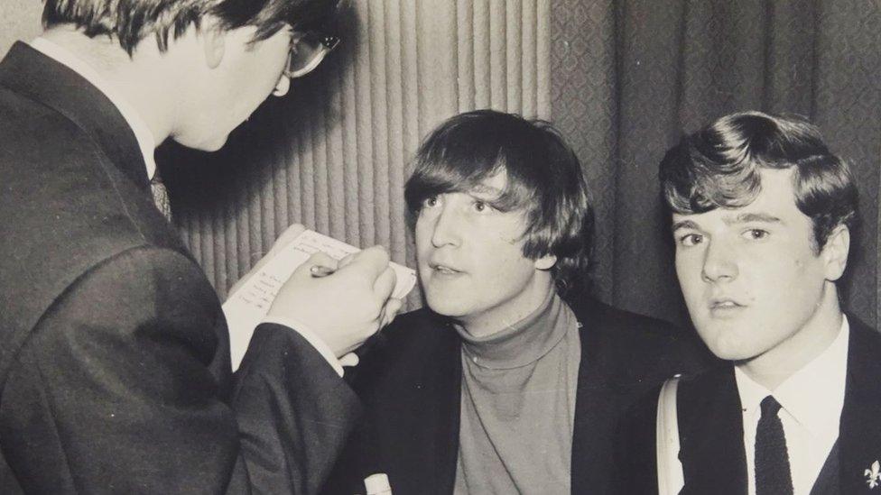 John Lennon (middle) interviewed by students in 1964