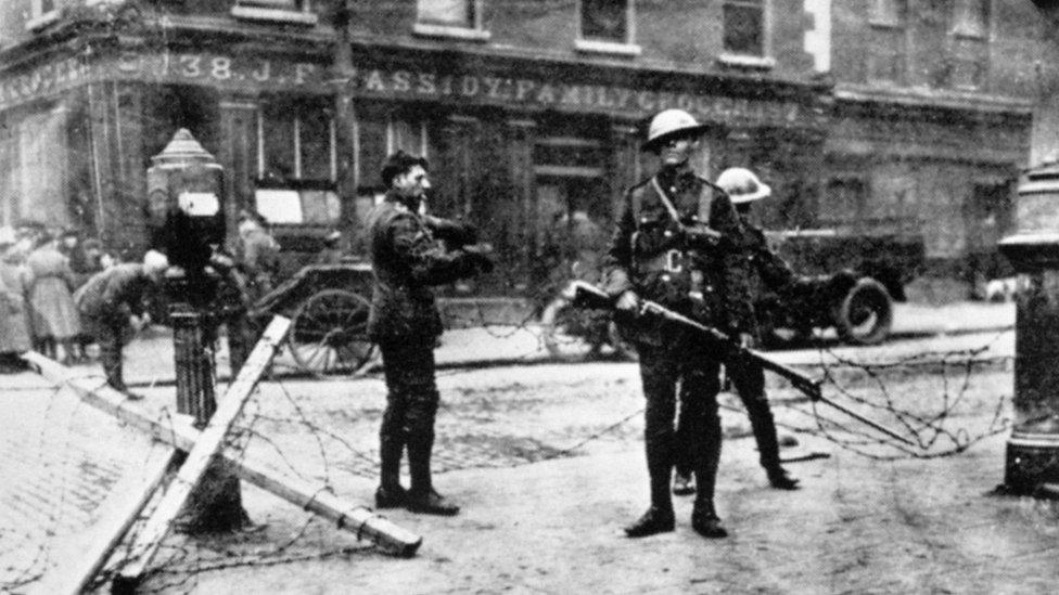 British soldiers man a roadblock outside Cassidy's grocery shop in Dublin during the 1916 Easter Rising