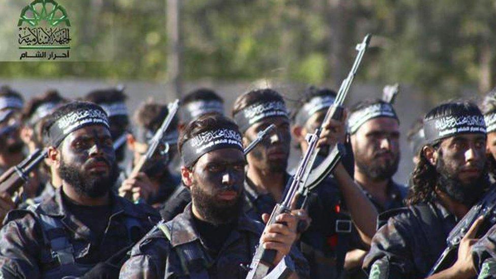 fighters from Ahrar al-Sham march in the eastern Damascus suburb of Ghouta, Syria