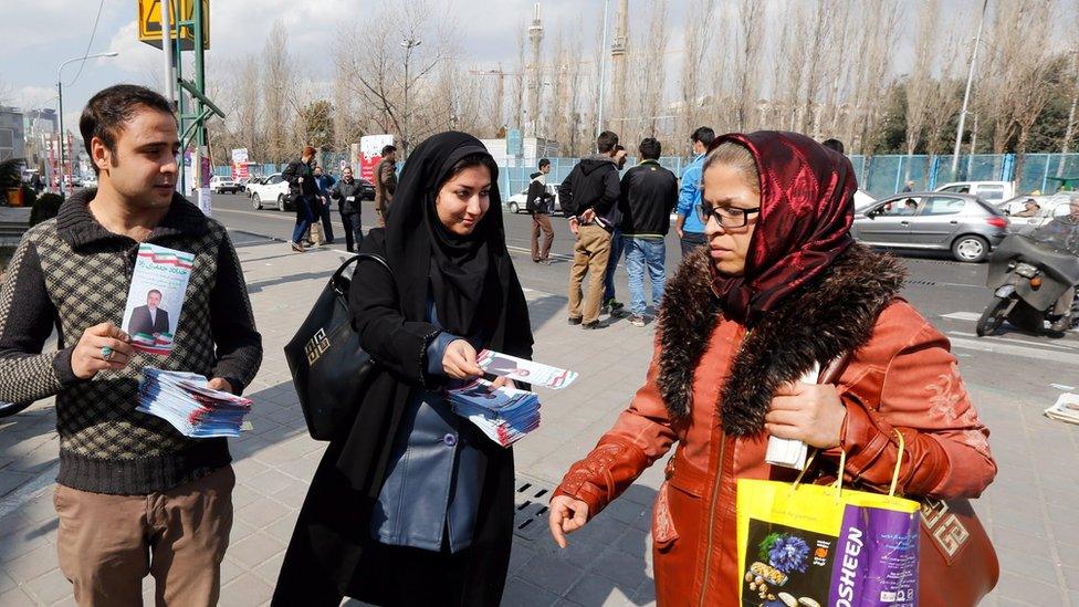 Iranian election campaign workers distribute election information of candidates of parliamentary and the Assembly of Experts elections in a street of Tehran, 19 February 2016.