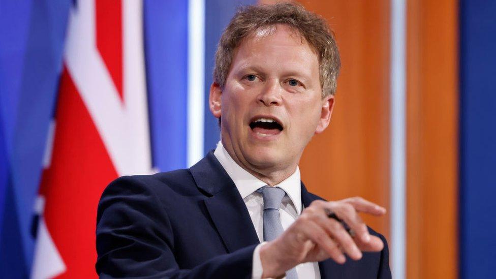 grant shapps speaking at downing street with the uk's union flag behind him