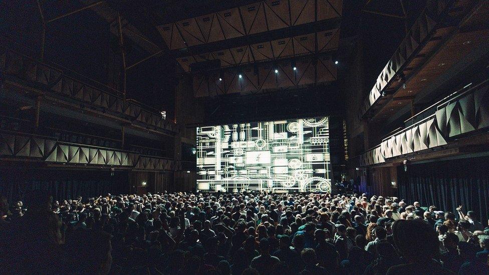 Simple Things Festival showing a packed main hall at the Bristol Beacon with the stage illuminated