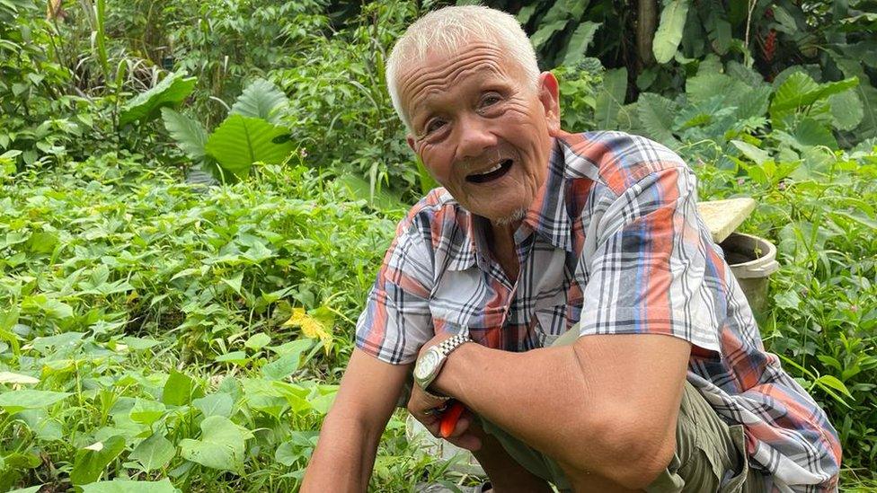 Mr Oh tends his garden in the forest.