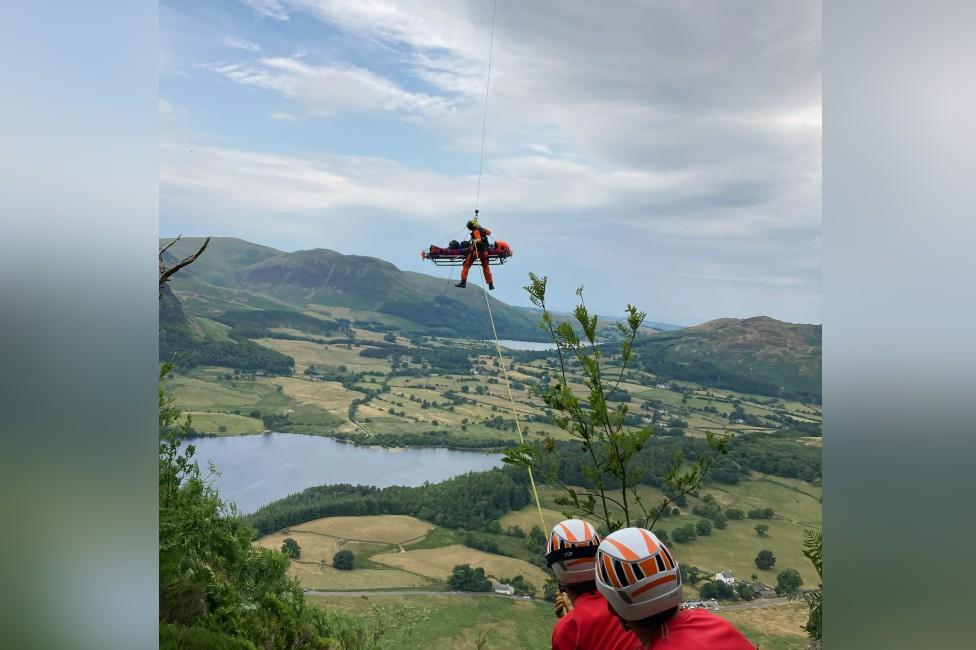 The casualty being winched to a helicopter on a stretcher