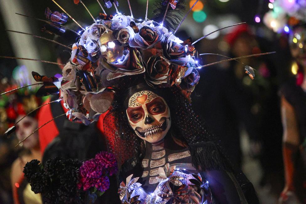 Participants dressed as the popular Mexican figure Catrina perform during a parade, as part of the Day of the Dead celebrations, in Mexico City, Mexico 22 October, 2023.