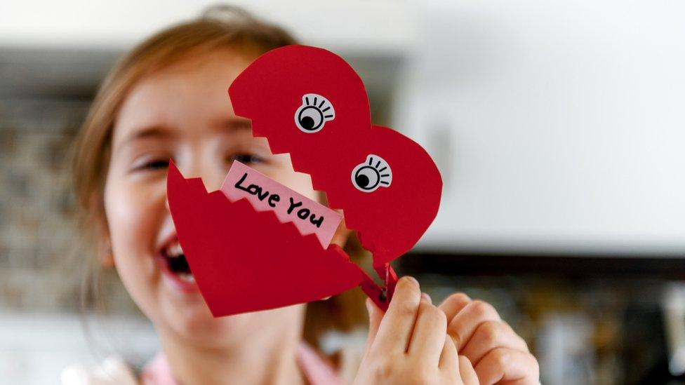 girl-holding-valentines-card.