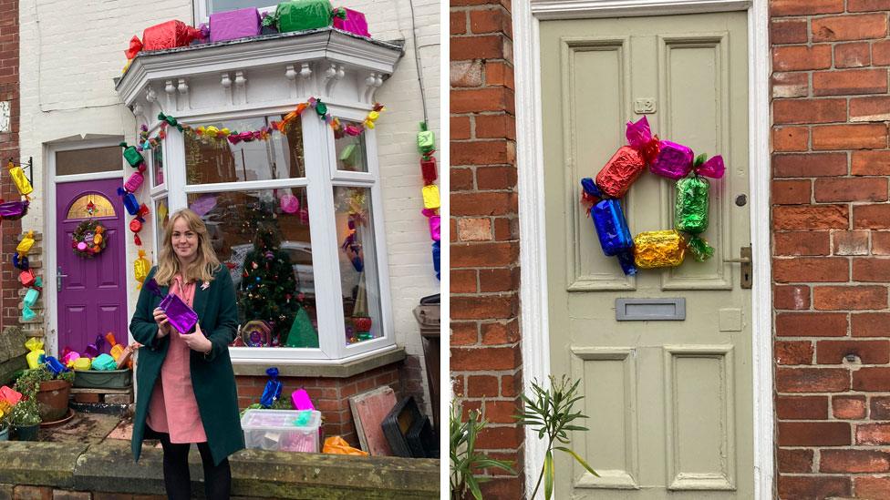 Kayleigh Thomas stands outside her home which is decorated with oversized Quality Street replicas