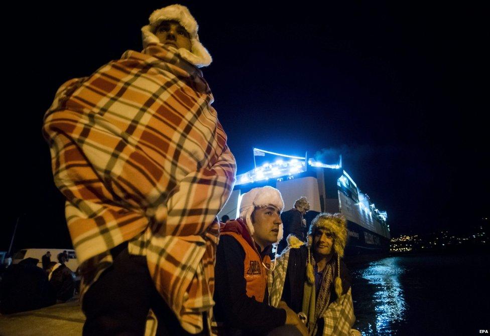 Migrants wait to board a ferry for Athens in the port of Mitilini, on the Greek island of Lesbos, 3 December 2015