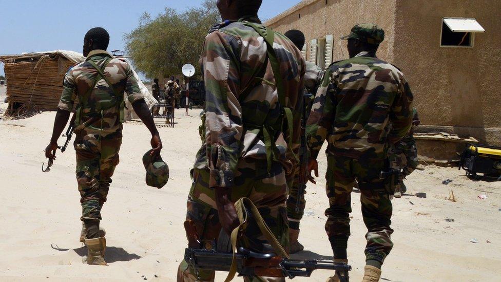 Nigerien soldiers patrol along the Nigerian border, near the south-eastern city of Bosso, on May 25, 2015.