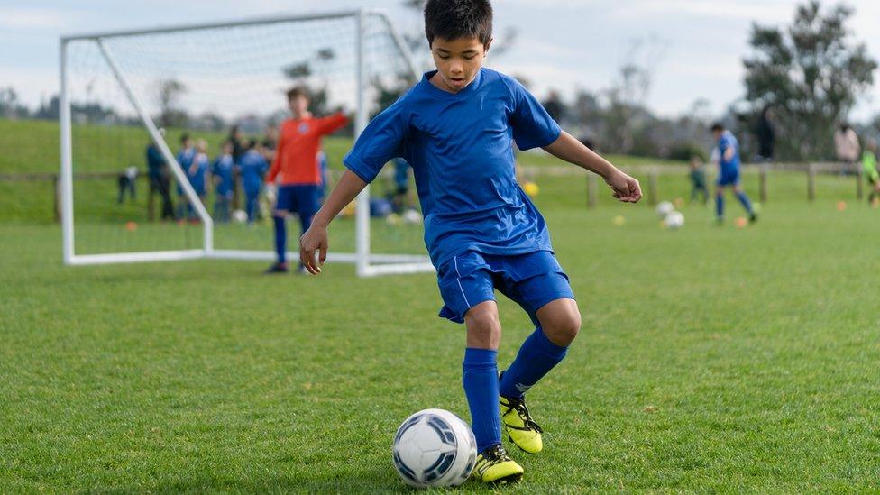 kid playing football