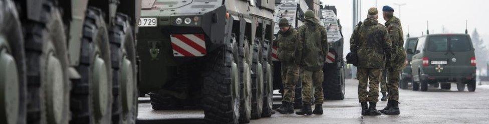 Members of the Bundeswehr, the German armed forces, load Boxer military vehicles onto a train in order to ship them and other equipment to Lithuania on January 31, 2017 in Grafenwoehr, Germany