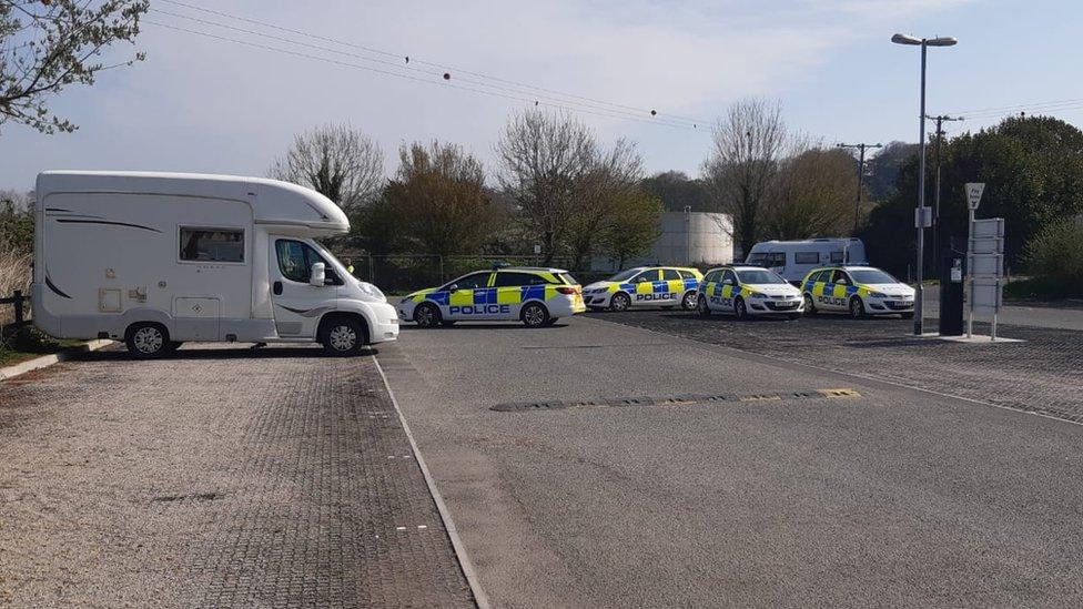 Four police cars and Mimi Gulliford's van in the car park