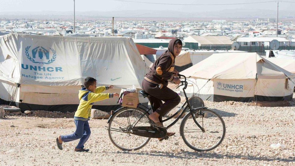 Young Syrian refugees play in the Zaatari Refugee Camp, in Jordan